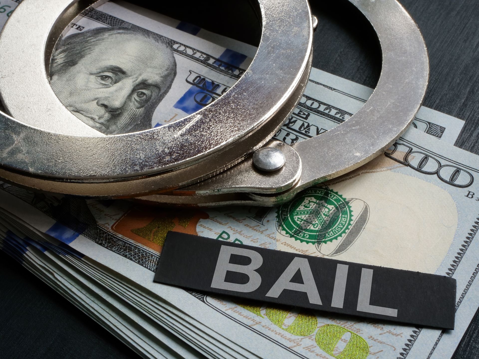 Handcuffs and money — bail bond release process